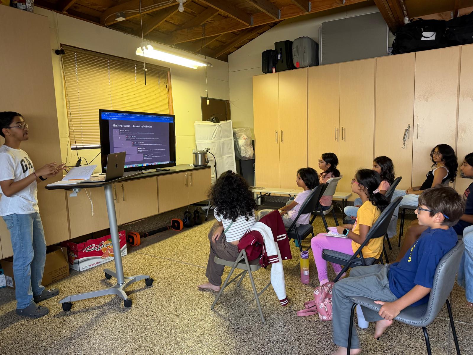 Vihaan teaching an August 2026 AI class with students